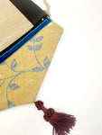 POCHETTE RIGATA NERO ORO CON NAPPINA BORDEAUX